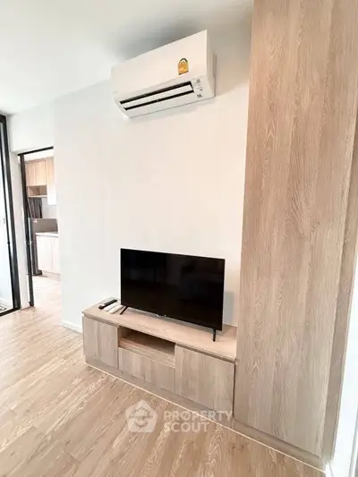 Modern living room with sleek wooden TV stand and air conditioning unit, perfect for cozy entertainment.