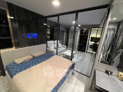 Modern bedroom with glass partition leading to stylish living area in luxury apartment.