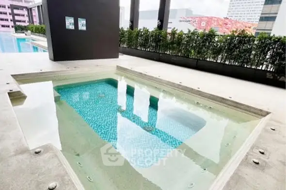 Luxurious pool area with modern design and city views, perfect for relaxation and leisure.