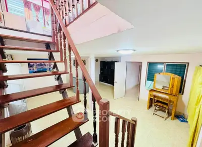Charming interior with wooden staircase and cozy living area, perfect for a warm family home.