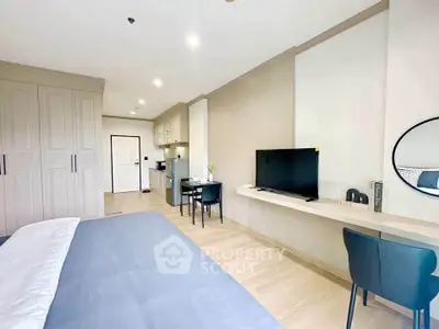 Modern studio apartment with sleek design and open layout, featuring a cozy living area and compact kitchen.