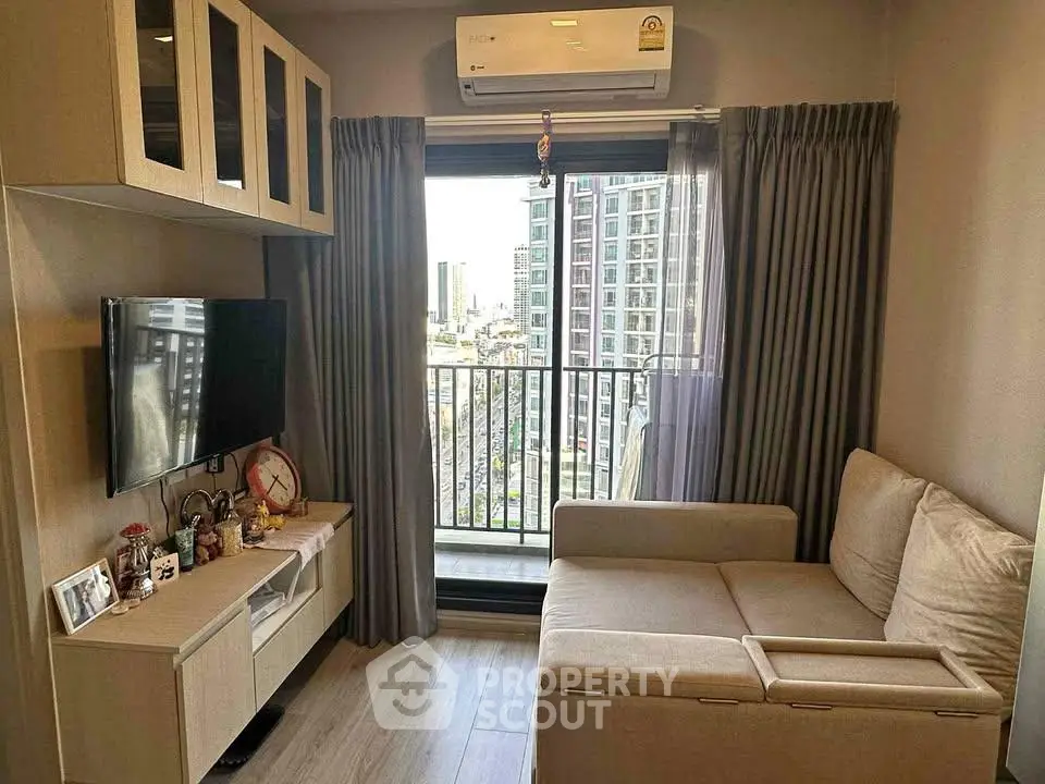 Modern living room with city view, featuring cozy sofa and wall-mounted TV, perfect for urban living.