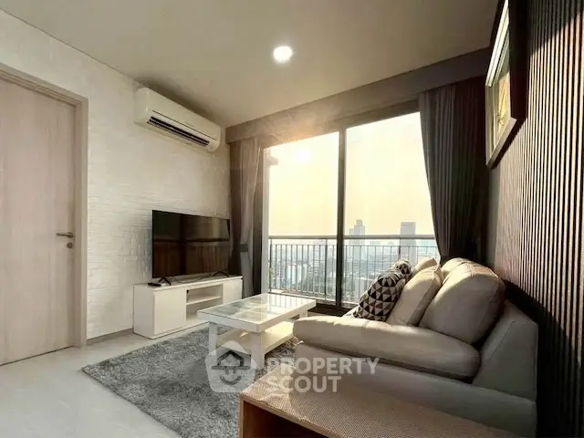 Modern living room with city view, stylish decor, and natural light.