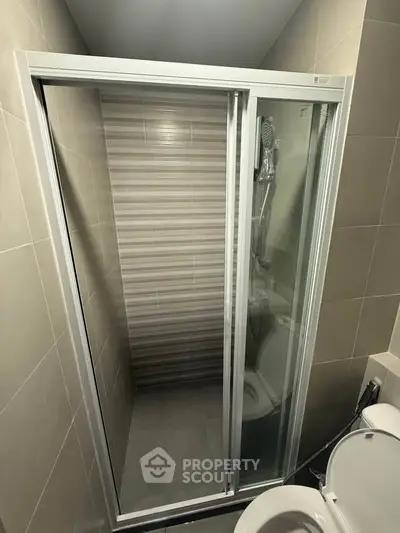 Modern bathroom with sleek shower enclosure and contemporary tiles