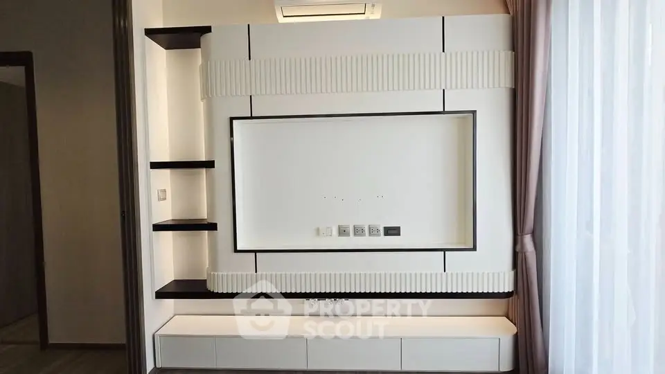 Modern living room with sleek built-in TV unit and elegant shelving