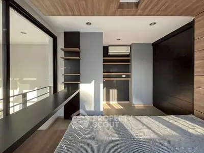 Modern bedroom with sleek design, large windows, and built-in storage solutions.