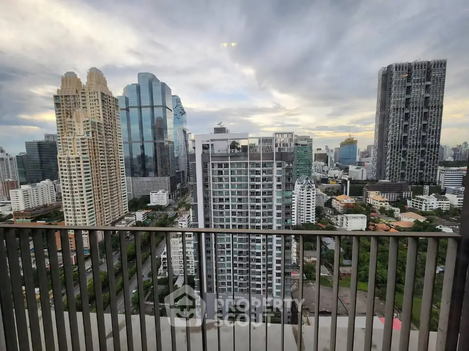 Stunning cityscape view from a high-rise balcony showcasing modern skyscrapers and urban skyline.