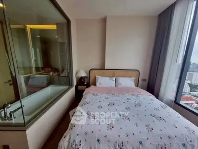 Cozy bedroom with city view and adjacent glass-walled bathroom