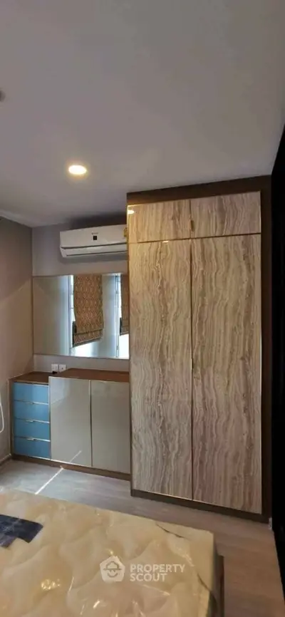 Modern bedroom with stylish wardrobe and air conditioning unit