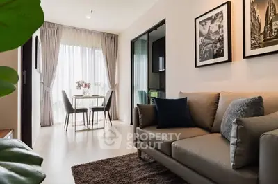 Modern living room with cozy sofa and dining area in stylish apartment.