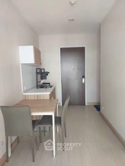Cozy minimalist kitchen with dining area in modern apartment