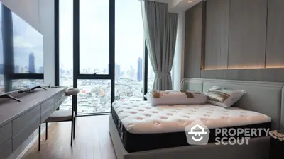 Luxurious bedroom with city view, modern furnishings, and floor-to-ceiling windows