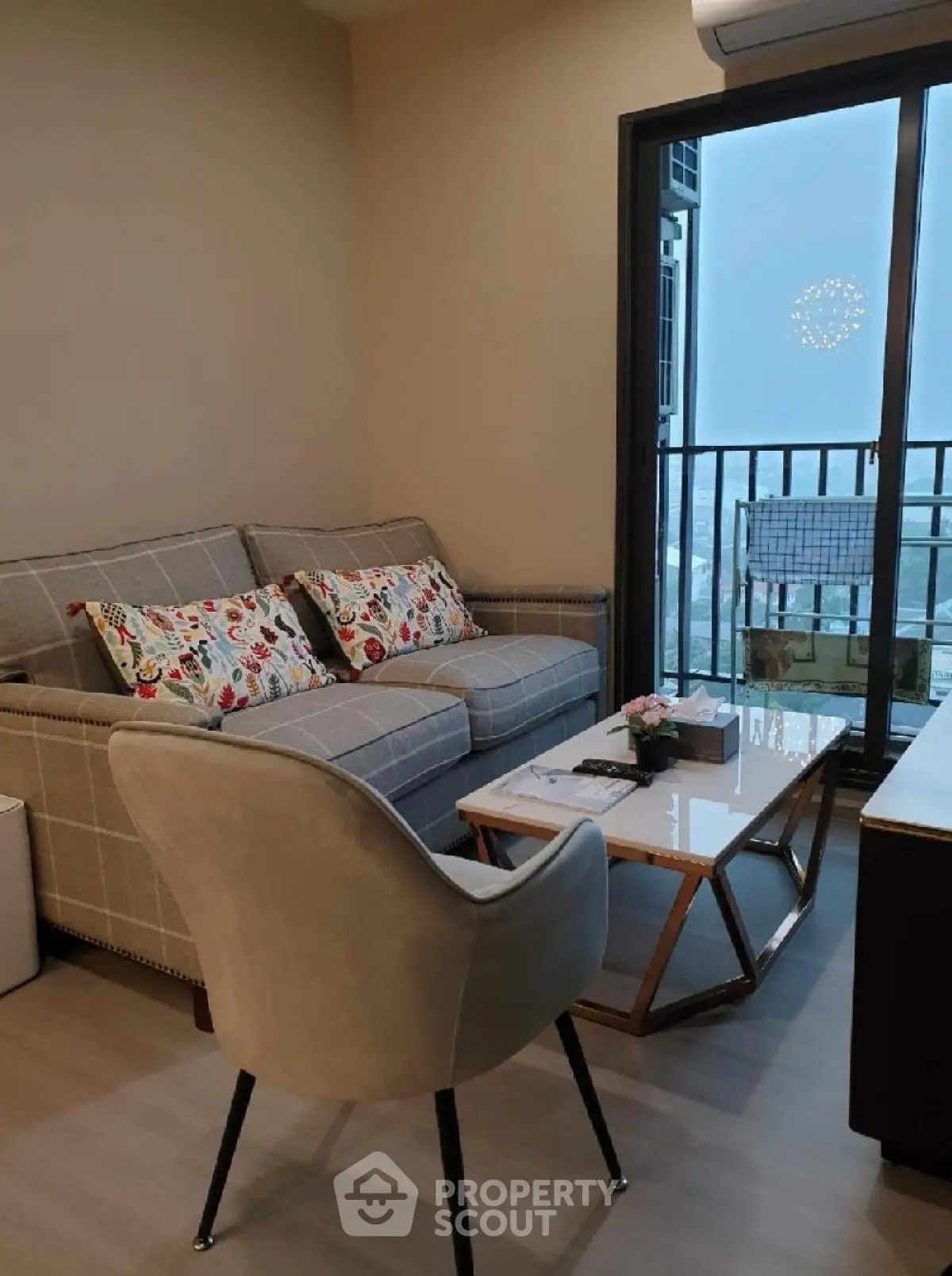 Cozy living room with stylish sofa and balcony view in modern apartment