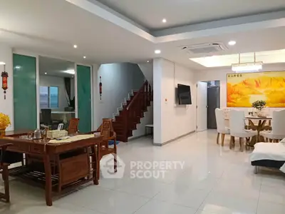 Spacious modern living room with elegant dining area and staircase