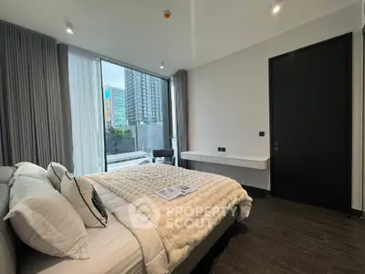 Luxurious modern bedroom with city view, featuring elegant decor and large windows for natural light.