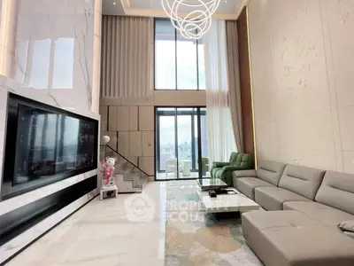 Luxurious modern living room with high ceilings, large windows, and elegant decor in a high-rise apartment.