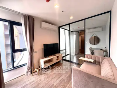 Modern living room with glass partition, stylish furniture, and natural light in a contemporary apartment.