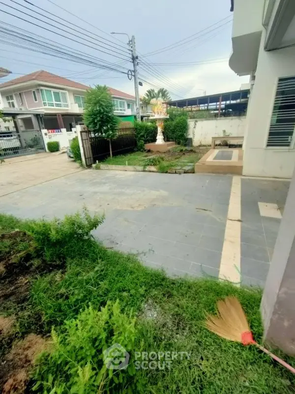 Charming suburban home with spacious driveway and lush greenery, perfect for family living.