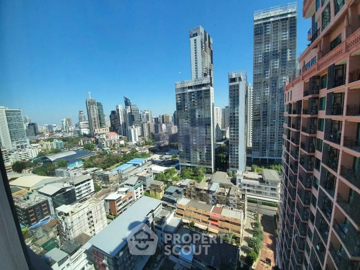 Stunning cityscape view from high-rise apartment window showcasing modern skyscrapers.