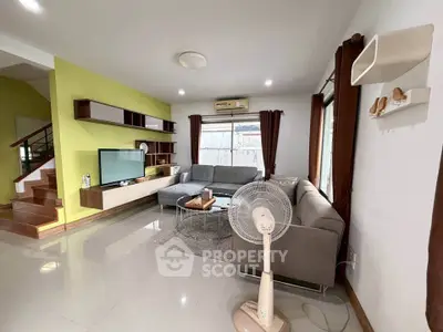 Spacious living room with modern decor and large windows for natural light.