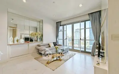 Luxurious living room with city view, elegant decor, and modern furnishings.