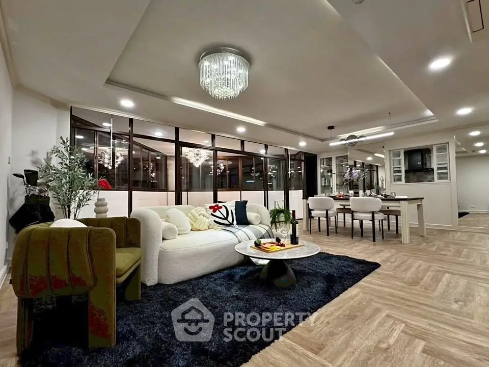 Luxurious open-plan living room with elegant decor and modern lighting