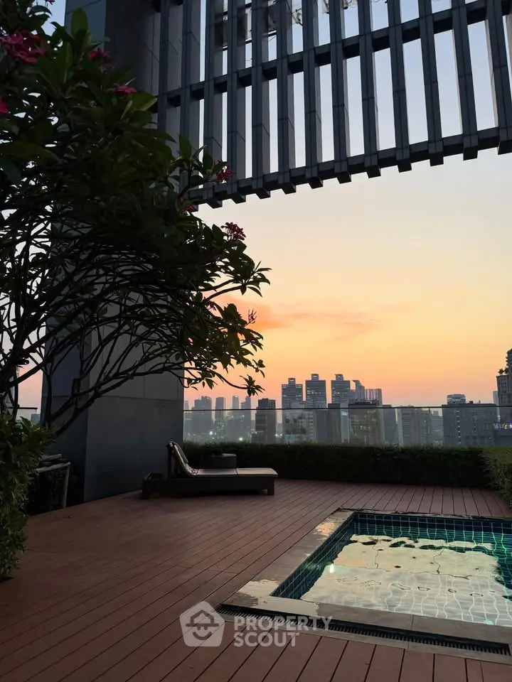 Stunning rooftop pool with city skyline view at sunset, perfect for luxury urban living.
