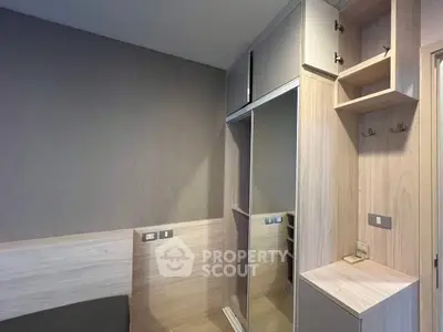 Modern bedroom with built-in wardrobe and sleek wooden finishes
