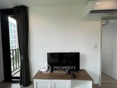 Modern living room with balcony and air conditioning in a stylish apartment.