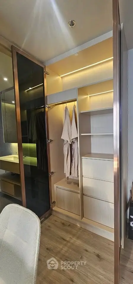 Spacious walk-in closet with modern lighting and ample storage space