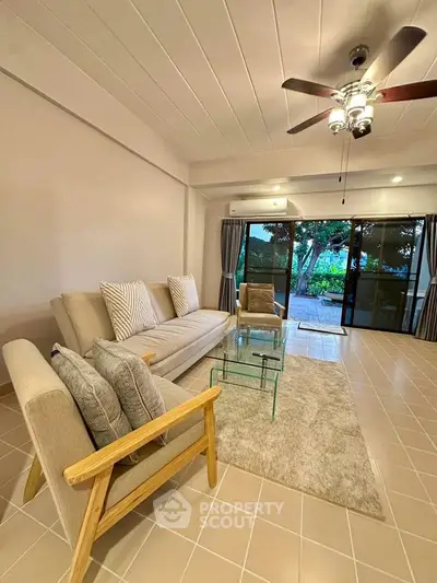 Spacious living room with modern decor and garden view, perfect for relaxation.