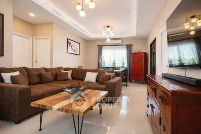 Spacious living room with modern lighting and stylish furniture