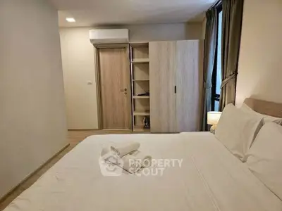 Cozy bedroom with modern furnishings and ample storage in a stylish apartment.