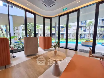 Luxurious modern living room with panoramic garden and pool view, featuring elegant furniture and floor-to-ceiling windows.