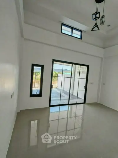 Spacious room with large windows offering stunning views and abundant natural light.