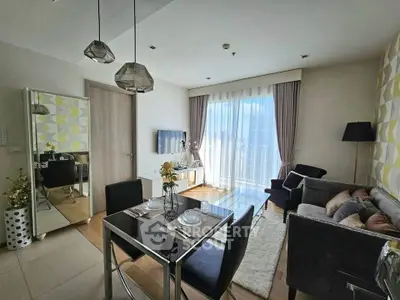 Modern living room with dining area, stylish decor, and large window for natural light.