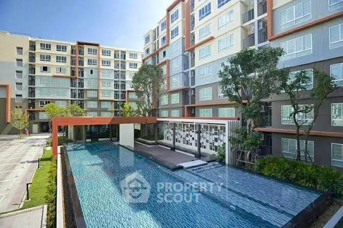 Modern apartment complex with a stunning outdoor pool and lush landscaping.