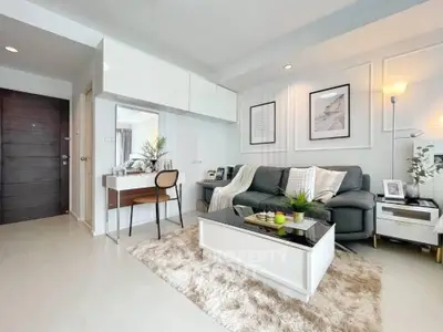 Modern living room with stylish decor, cozy sofa, and elegant coffee table in a bright apartment.