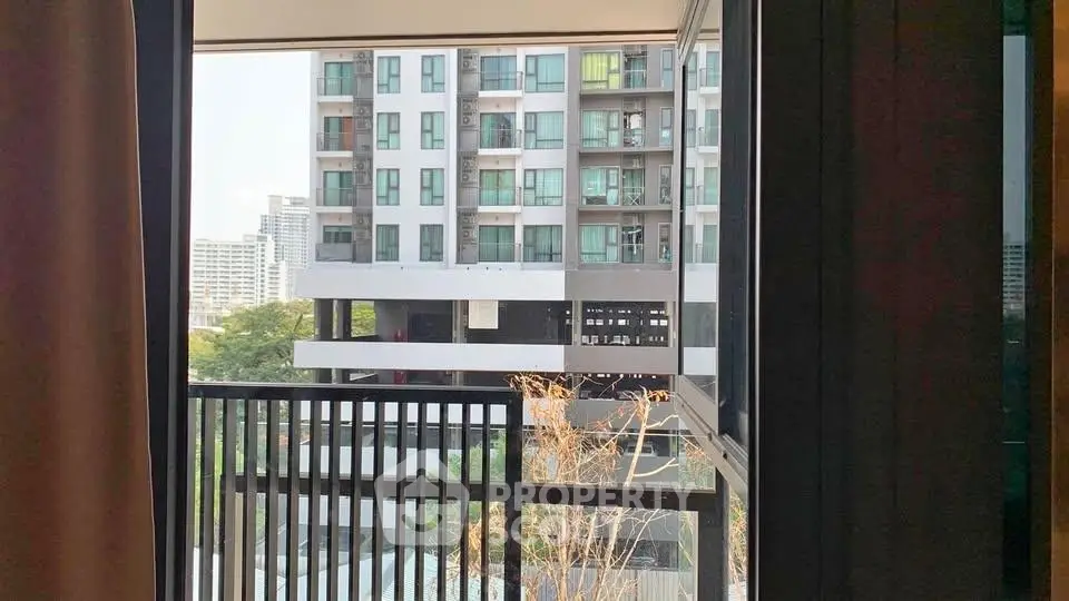 Modern apartment balcony with city view, showcasing urban living and contemporary architecture.