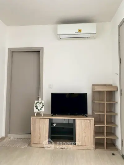 Modern living room with sleek TV stand and air conditioning unit, perfect for cozy entertainment.