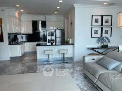 Luxurious open-layout kitchen and living area with modern design and elegant furnishings.