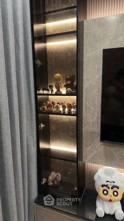 Stylish living room with modern display cabinet and unique decor items.