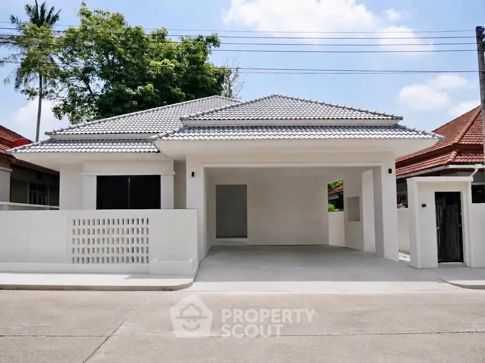 Charming single-story house with modern design and spacious driveway in a serene neighborhood.