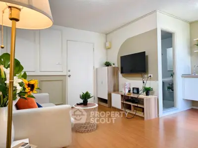 Charming living room with modern decor and open kitchen layout