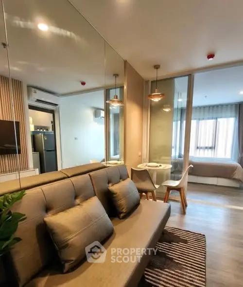 Modern studio apartment with open layout, featuring a cozy living area and stylish bedroom.