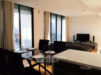 Modern living room with floor-to-ceiling windows and elegant dining area in a high-rise apartment.