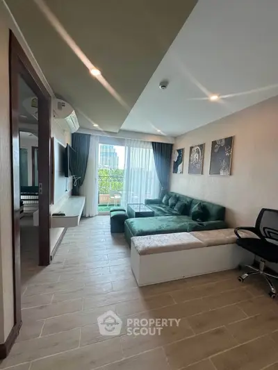 Spacious living room with modern decor and large windows opening to a balcony with city views.