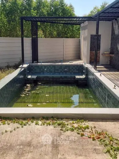 Charming outdoor pool area with modern design and lush greenery, perfect for relaxation and entertainment.