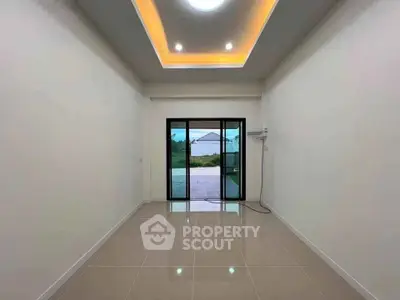 Spacious unfurnished room with modern ceiling lights and large window view.