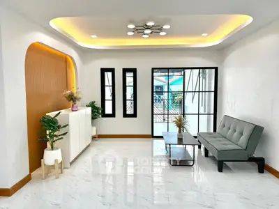 Modern living room with stylish decor and large windows offering natural light.